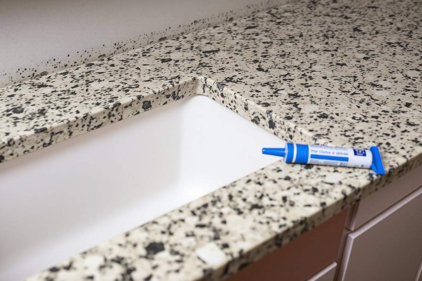 Stone kitchen countertop seam being set over new base cabinets
