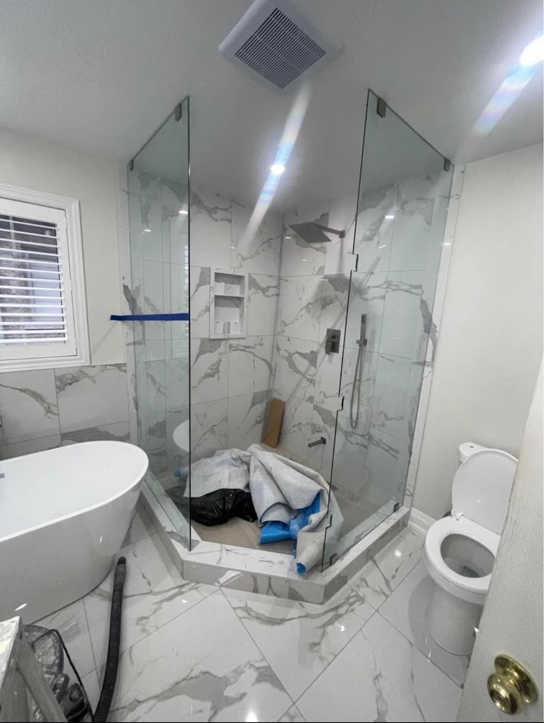 Marble ensuite with neo-angle glass shower, Muskoka