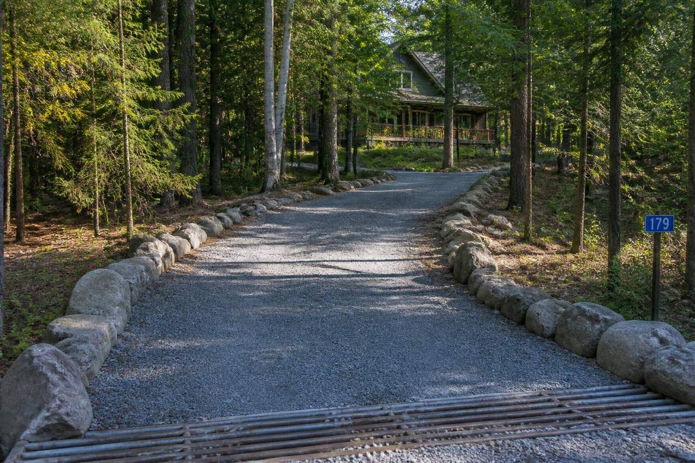 Freshly graded gravel driveway through a Muskoka pine forest