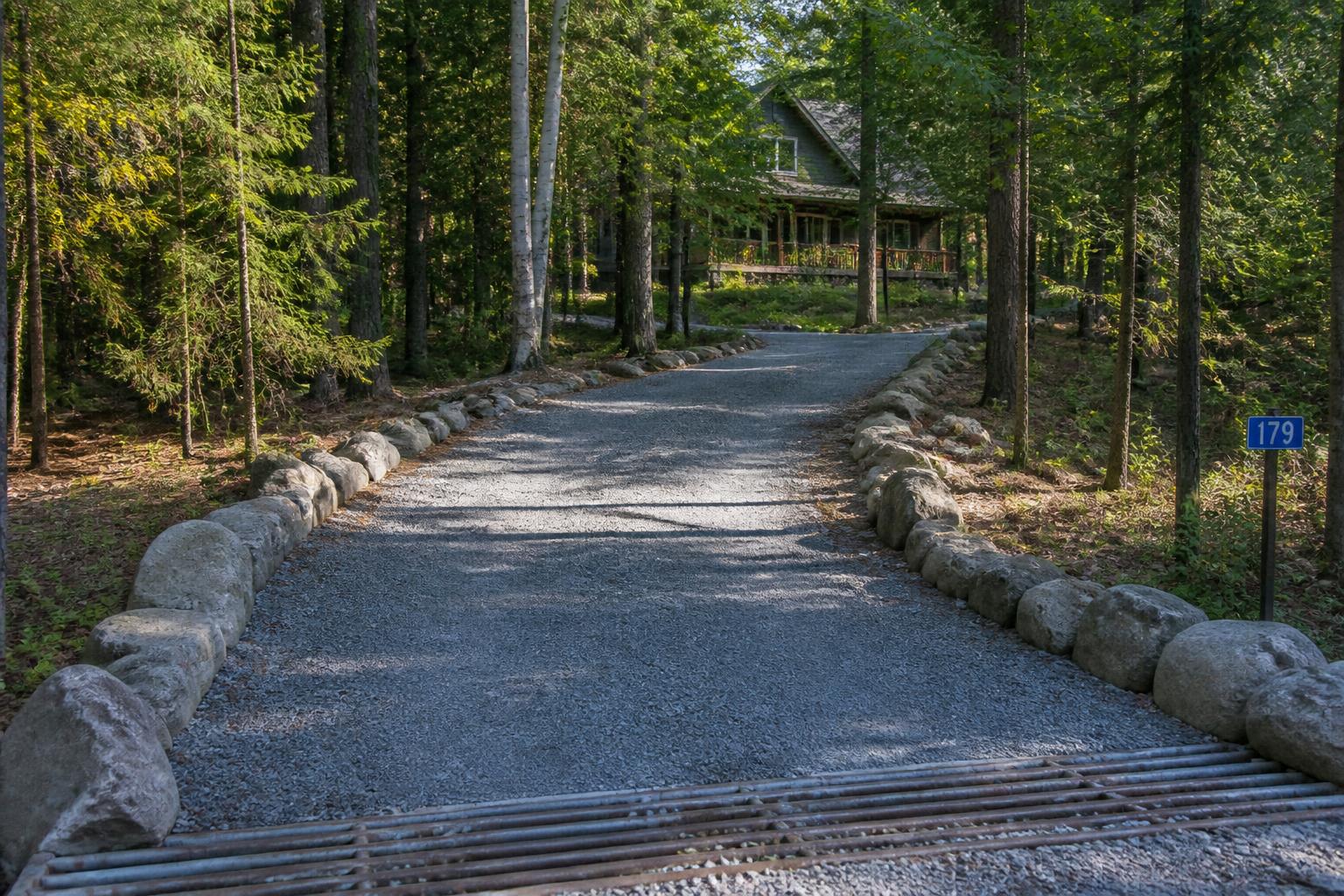 Freshly graded gravel driveway through a Muskoka pine forest